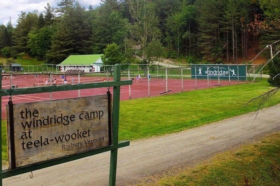 Entrance sign and red clay tennis courts at Windridge Camp at Teela-Wooket in Roxbury Vermont