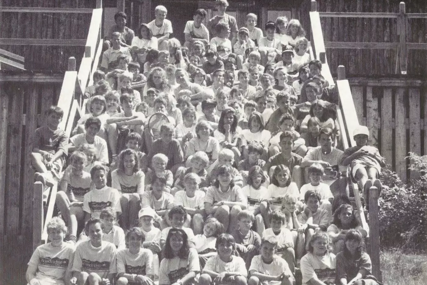 Vintage black and white group photo of Windridge campers and staff on the bleachers in Vermont