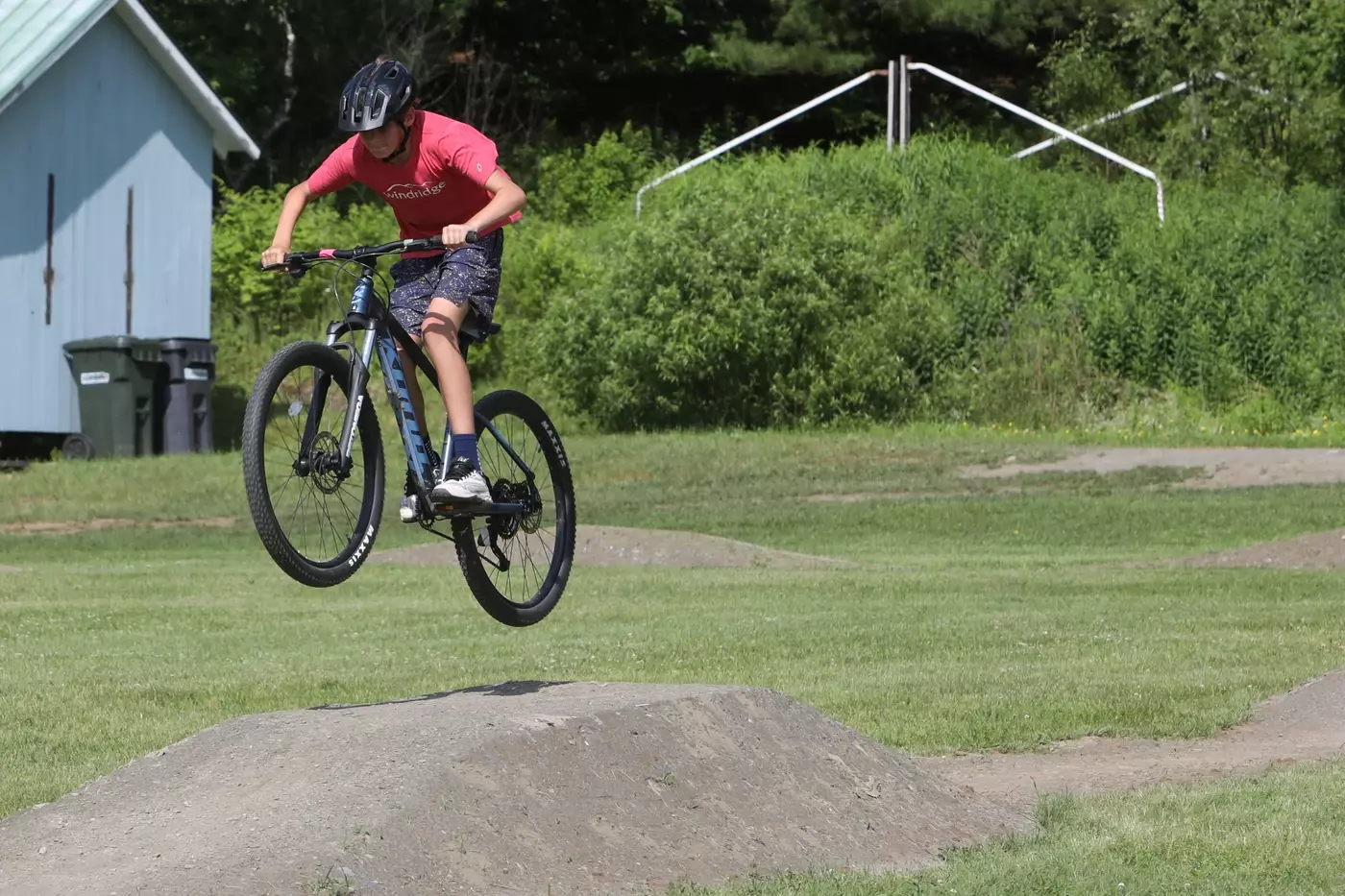 A mountain biker hits the flow trail at Windridge Summer Camp.