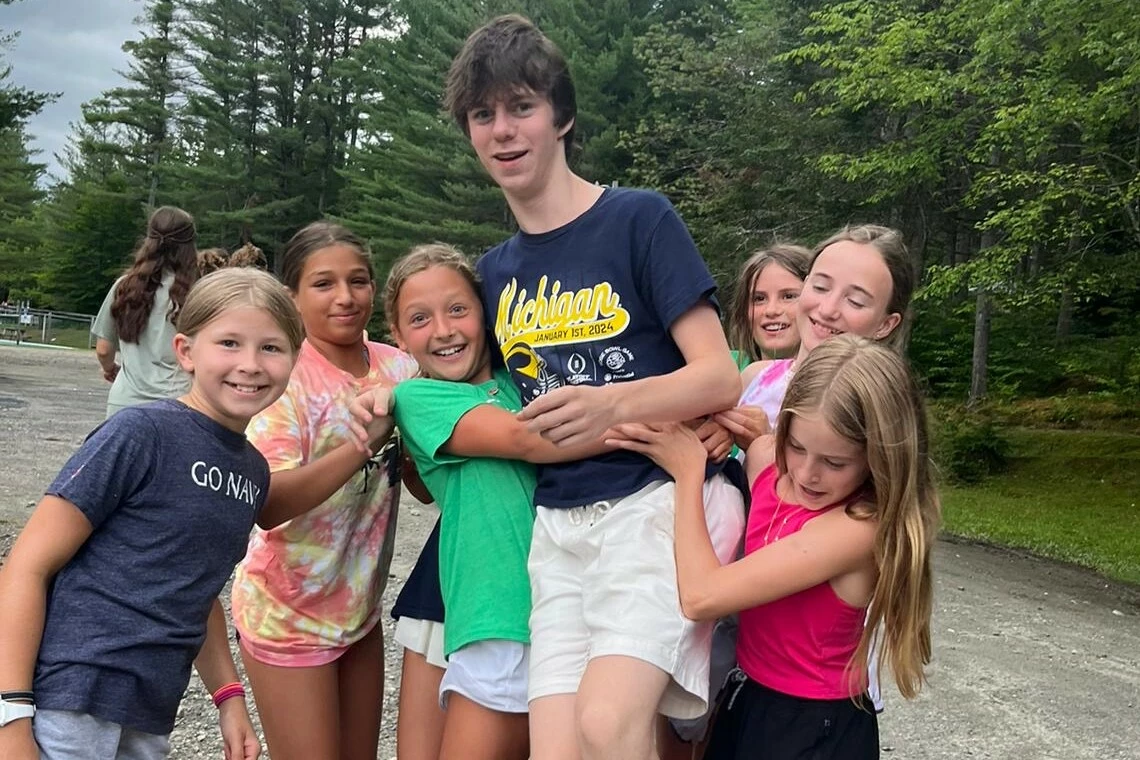 A group of campers lift up a CIT