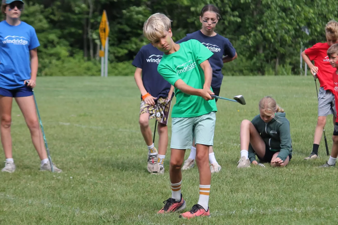 A junior golfer works on his short game during the golf elective.