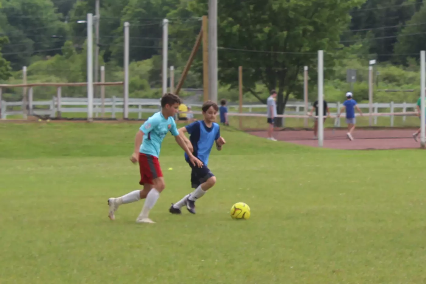 Two soccer players on the Windridge pitch.