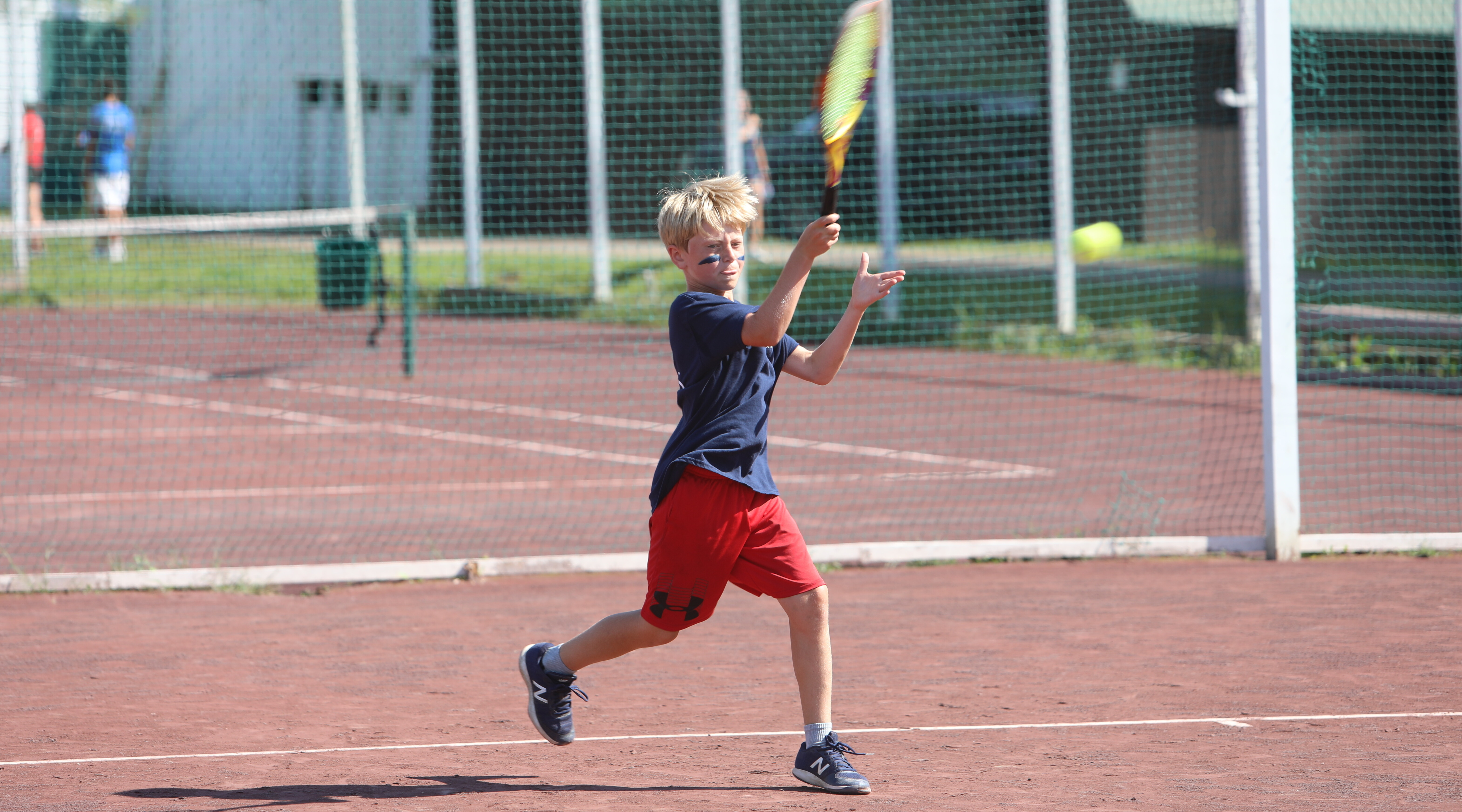 Camper playing tennis